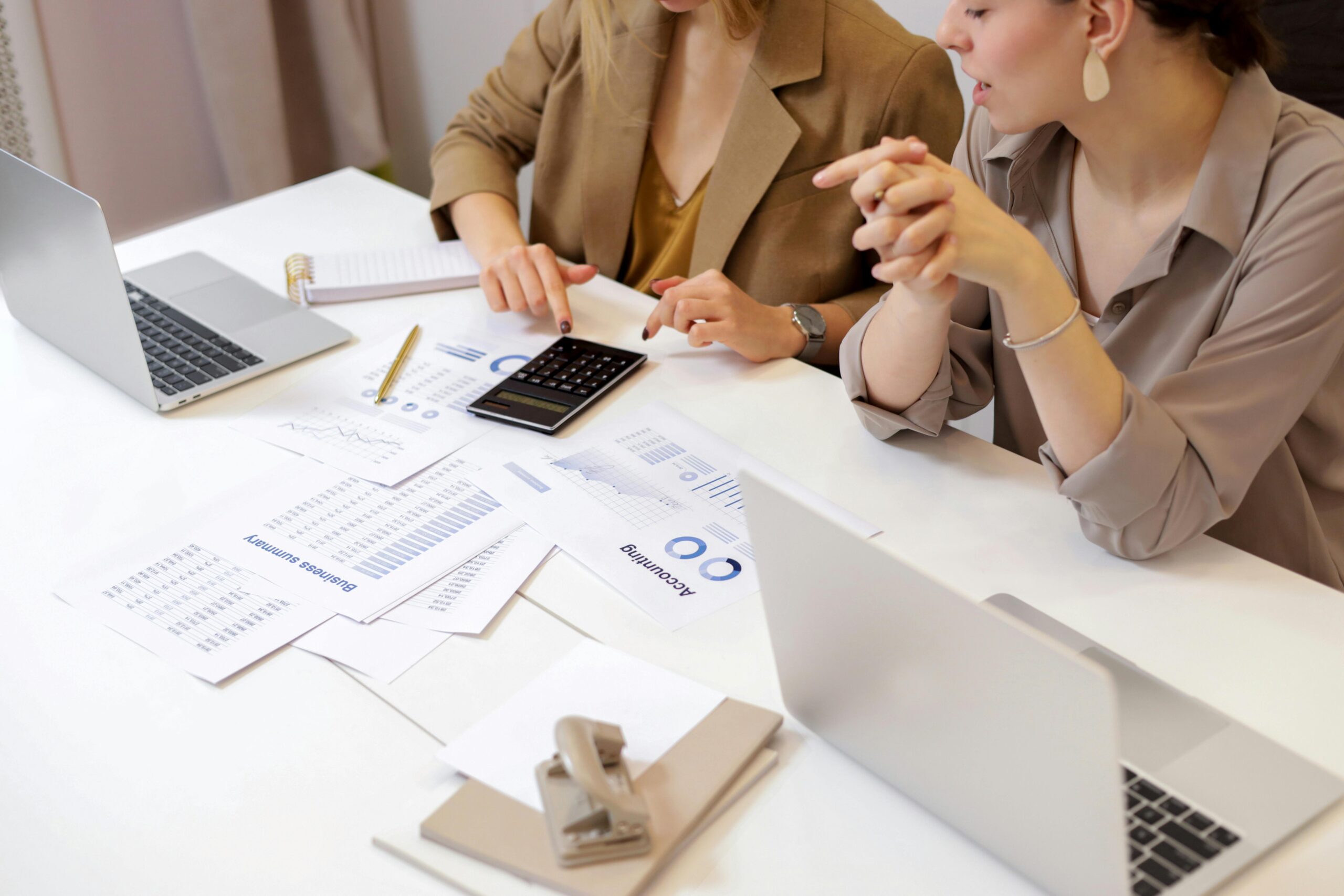 Two people filing their taxes at a desk